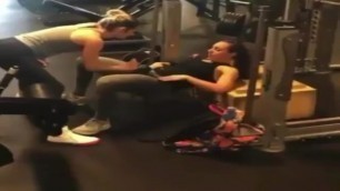 Two Lesbian Hot Girls Working Hard with a Dildo in Gym