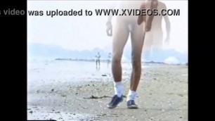 amatorial young boy walking naked on the beach